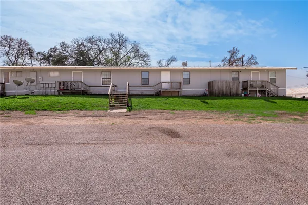 a view of a house with backyard and porch