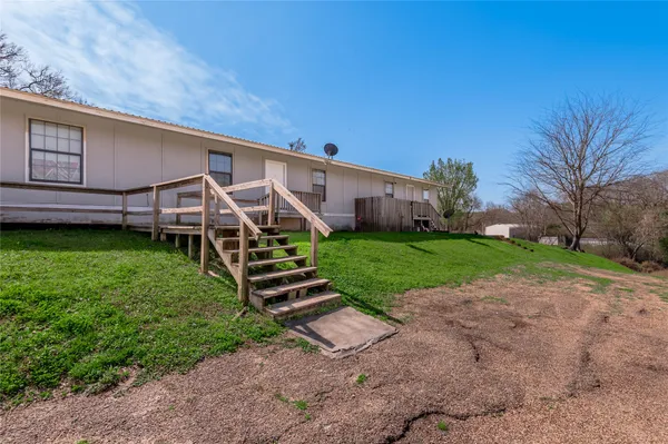 a view of a backyard with sitting area