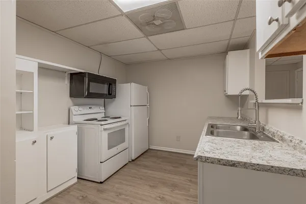 a kitchen with a sink dishwasher and cabinets
