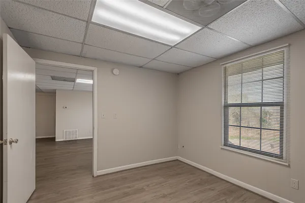 a view of an empty room with wooden floor