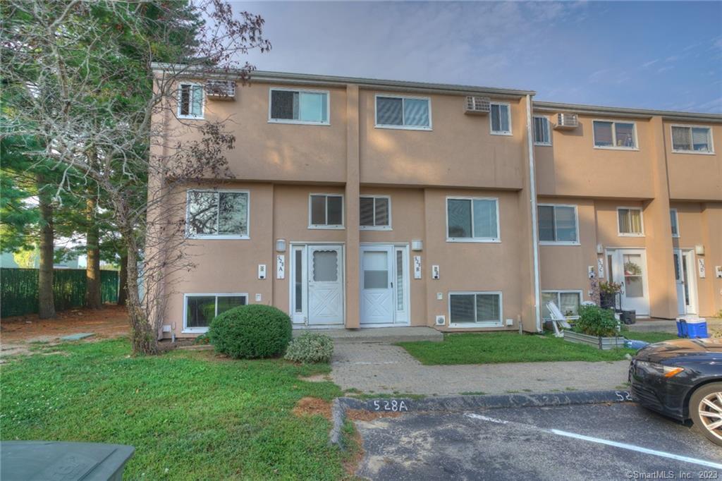 528 Shennecossett Road, Unit 14 Groton, CT 06340 - Photo 1 of 18 a front view of a house with a yard