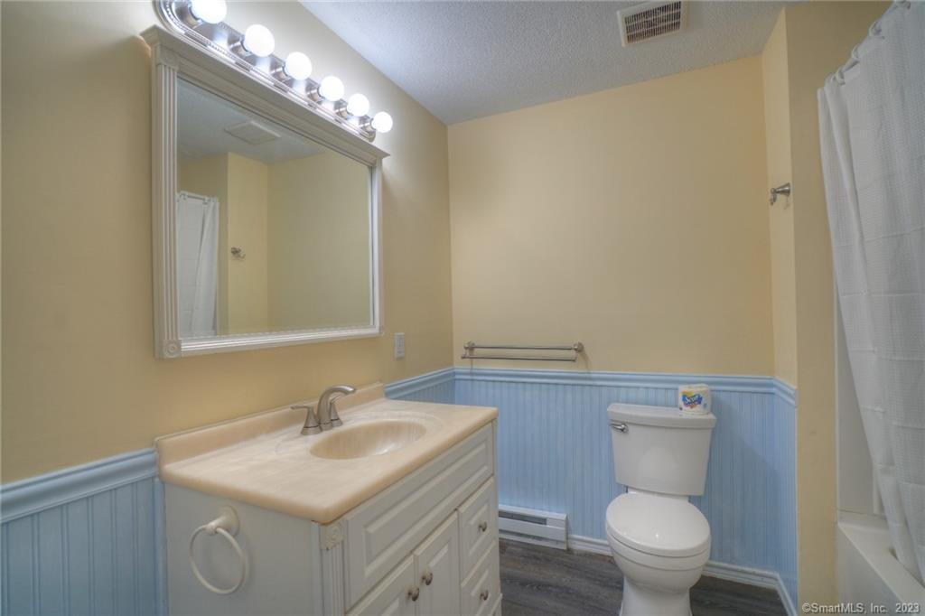 528 Shennecossett Road, Unit 14 Groton, CT 06340 - Photo 12 of 18 a bathroom with a toilet a sink and mirror
