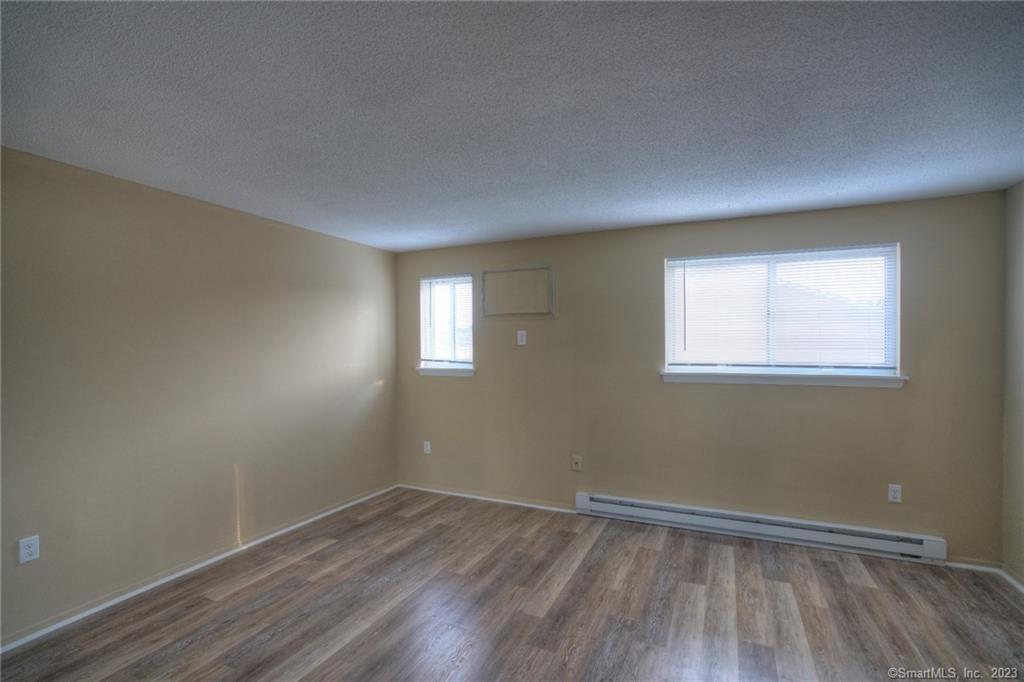 528 Shennecossett Road, Unit 14 Groton, CT 06340 - Photo 13 of 18 wooden floor in an empty room with a window