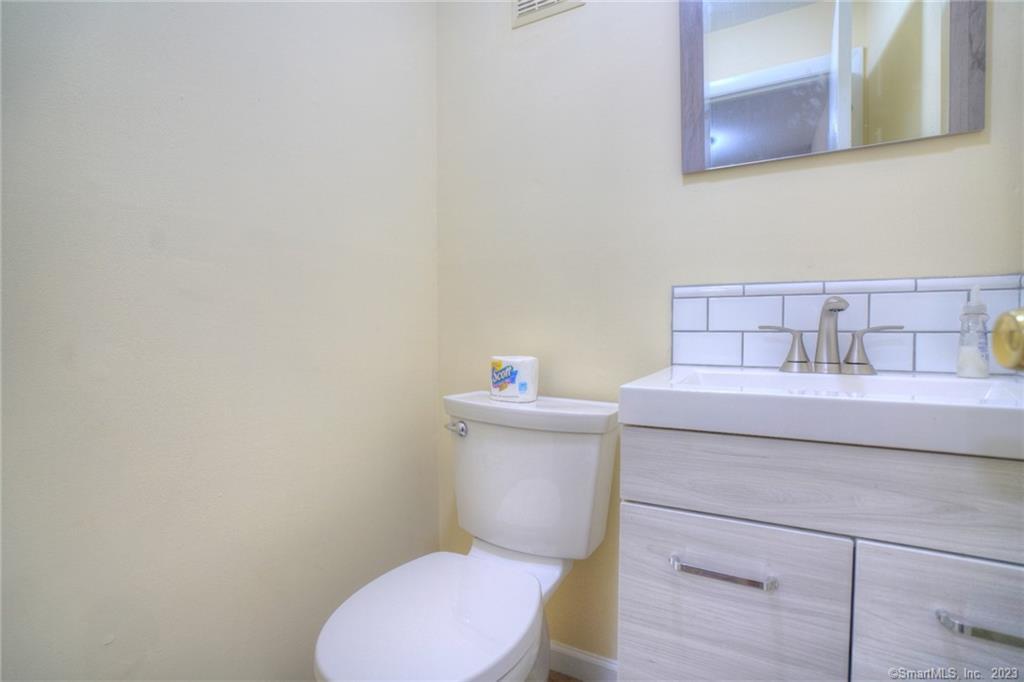 528 Shennecossett Road, Unit 14 Groton, CT 06340 - Photo 16 of 18 a bathroom with a sink a toilet and a mirror