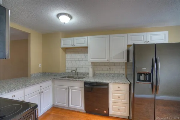 a kitchen with cabinets stainless steel appliances and a counter space