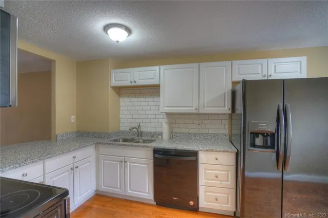 a kitchen with cabinets stainless steel appliances and a counter space