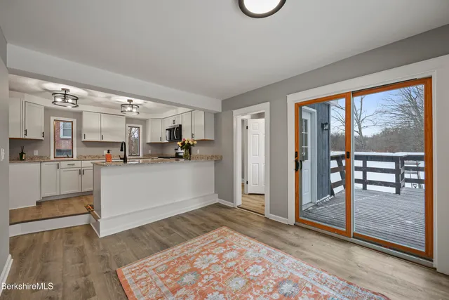a view of a kitchen with furniture and wooden floor