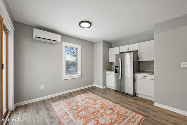 a view of a kitchen with a refrigerator cabinets and wooden floor