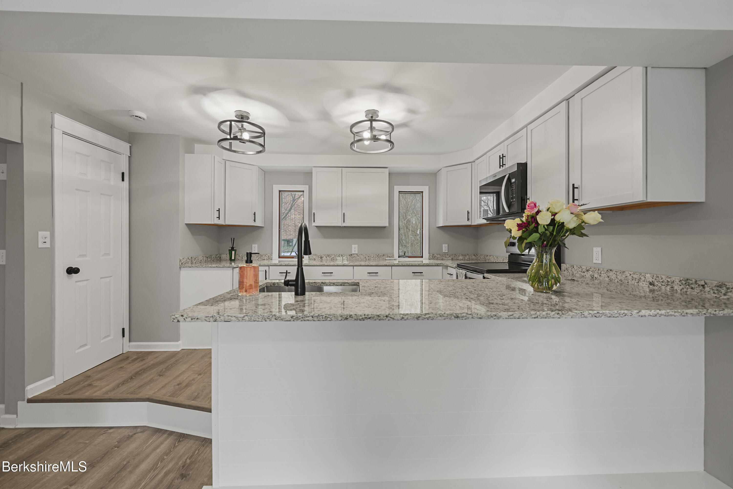 123 Broadview Terrace Pittsfield, MA 01201 - Photo 8 of 34 a view of a kitchen with kitchen island a sink wooden floor and counter top space