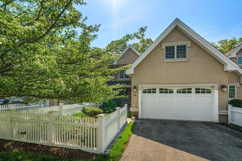 287 Langley Road, Unit 43 Newton, MA 02459 - Photo 35 of 36 a front view of a house with a garden