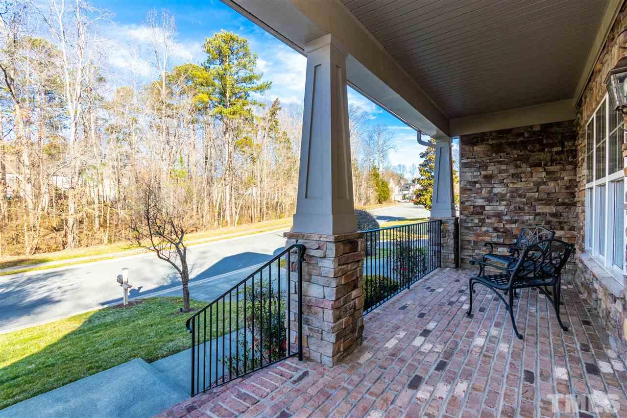 8240 Clarks Branch Drive Raleigh, NC 27613 - Photo 2 of 30 a view of a porch with a table and chairs