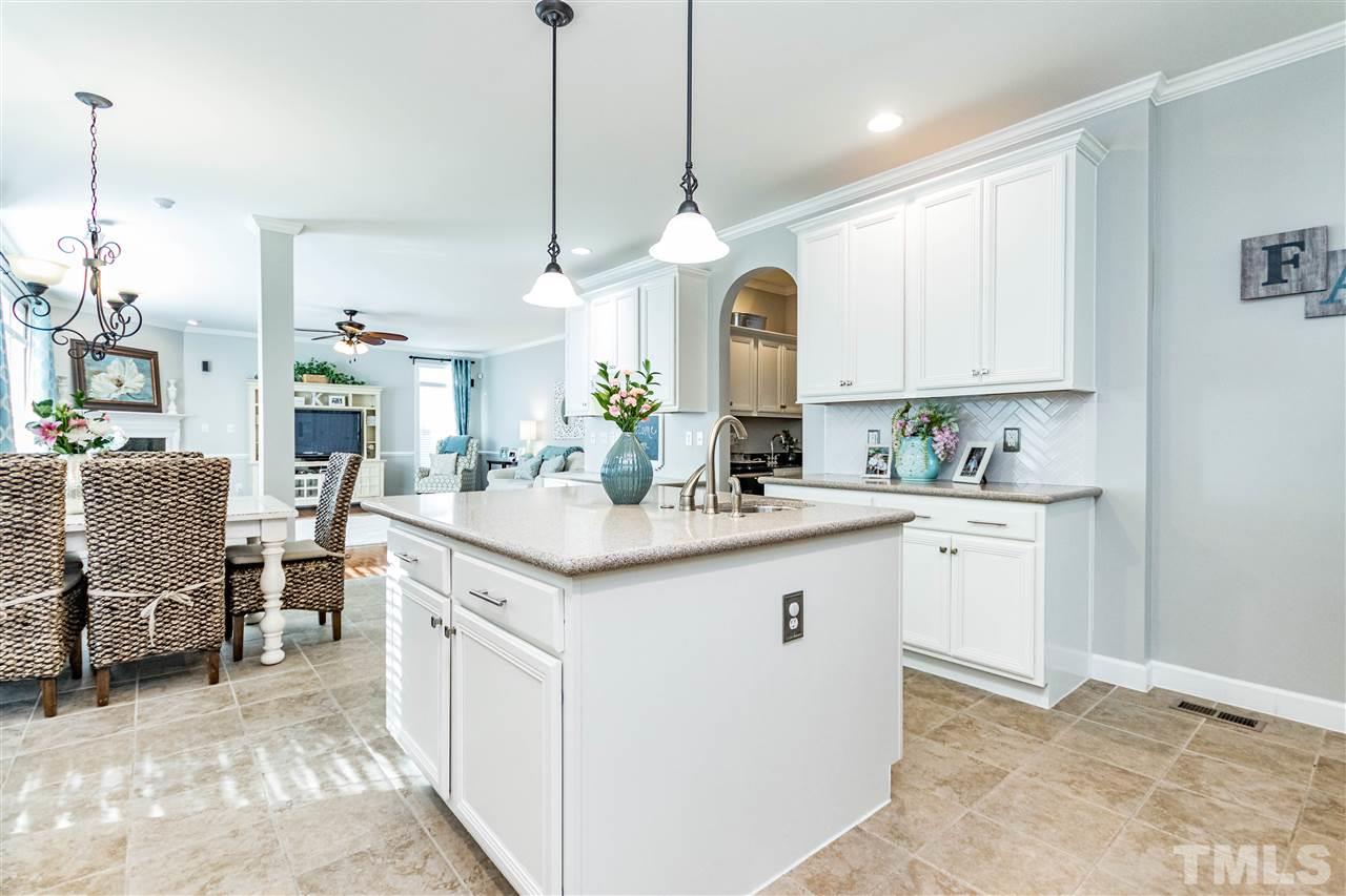 8240 Clarks Branch Drive Raleigh, NC 27613 - Photo 12 of 30 a kitchen with granite countertop a sink cabinets and stainless steel appliances