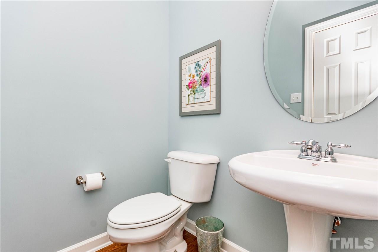 8240 Clarks Branch Drive Raleigh, NC 27613 - Photo 13 of 30 a bathroom with a toilet a sink and mirror