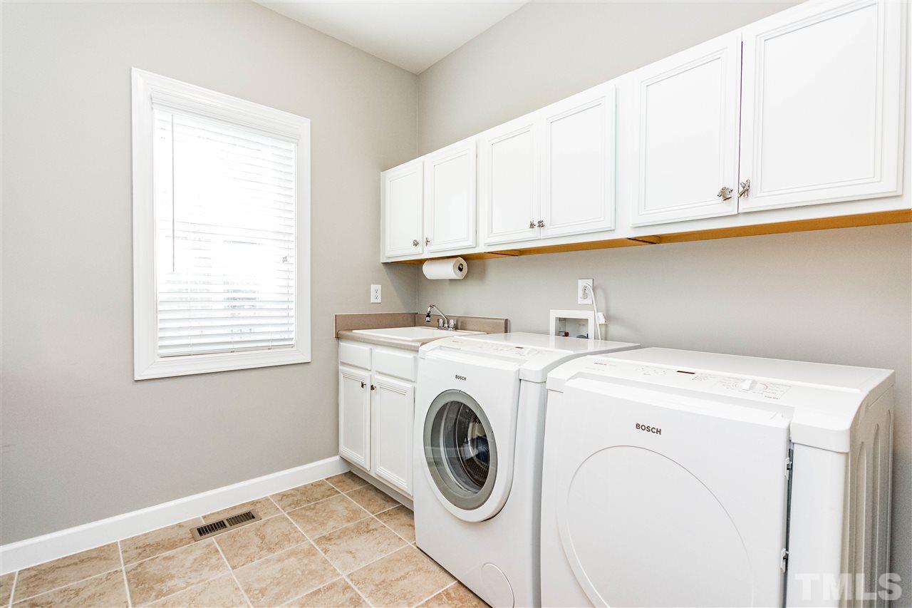 8240 Clarks Branch Drive Raleigh, NC 27613 - Photo 15 of 30 a utility room with dryer and washer