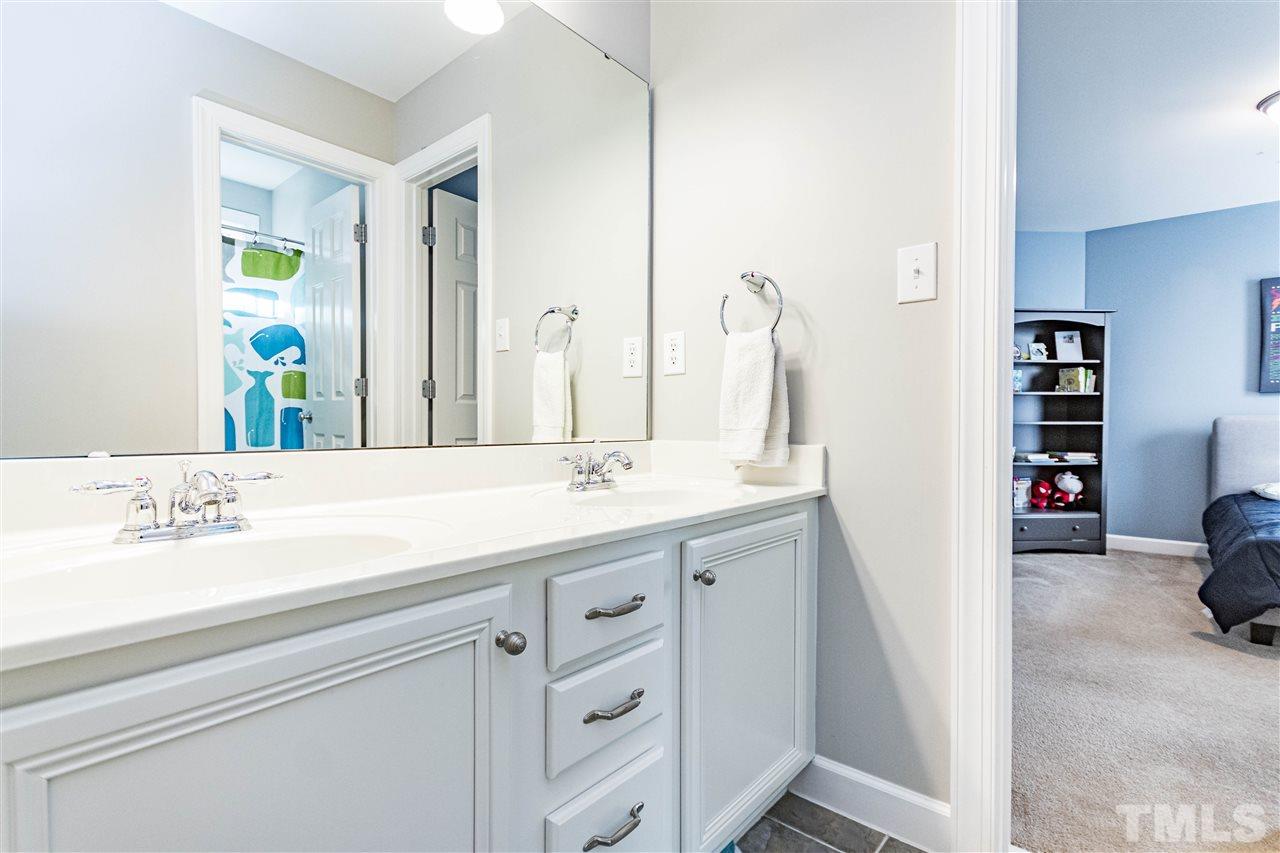 8240 Clarks Branch Drive Raleigh, NC 27613 - Photo 21 of 30 a bathroom with a sink double vanity and a shower
