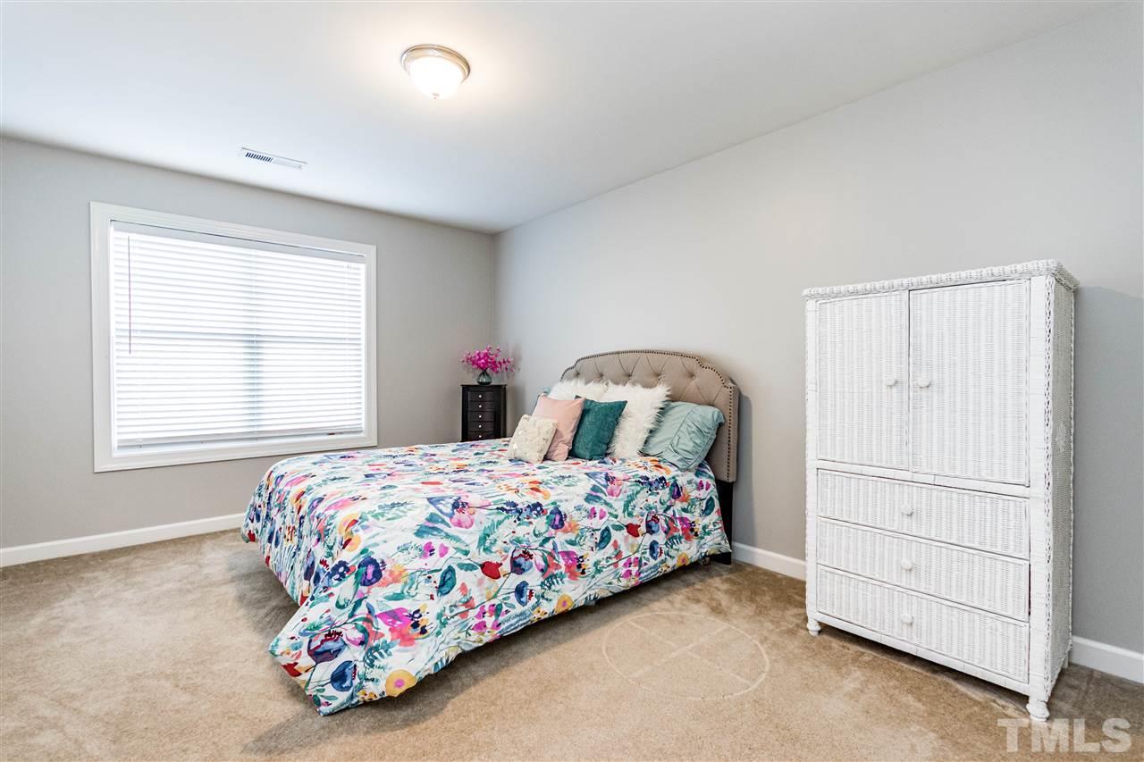 8240 Clarks Branch Drive Raleigh, NC 27613 - Photo 23 of 30 a bedroom with a bed and a window