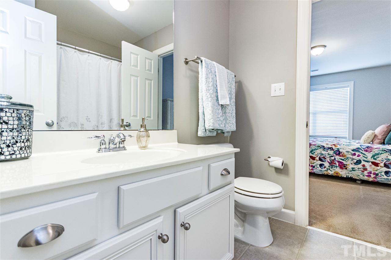 8240 Clarks Branch Drive Raleigh, NC 27613 - Photo 24 of 30 a bathroom with a sink vanity mirror and toilet