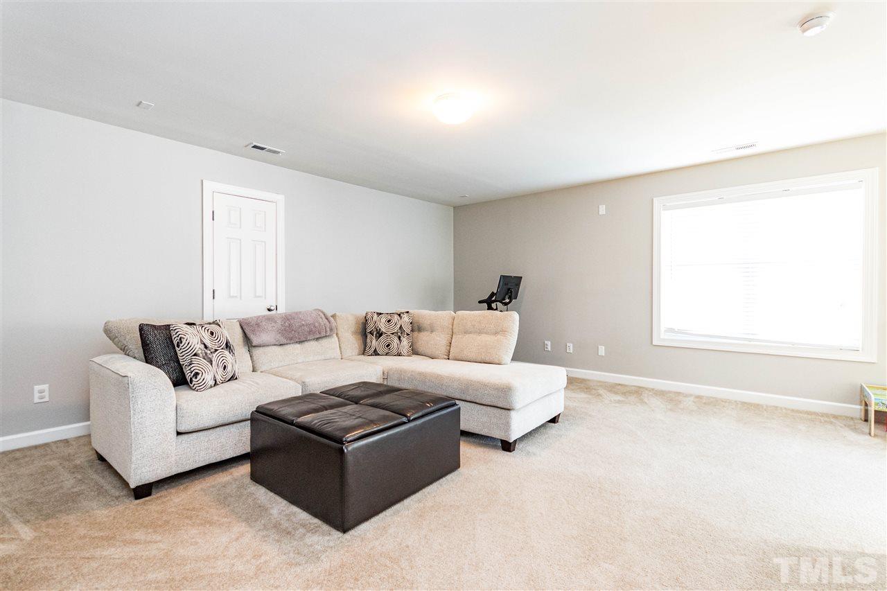 8240 Clarks Branch Drive Raleigh, NC 27613 - Photo 25 of 30 a living room with furniture and a large window