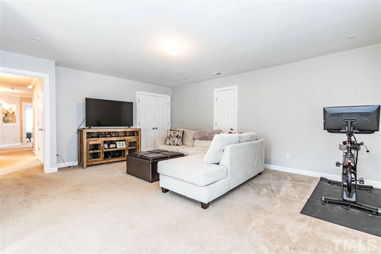 8240 Clarks Branch Drive Raleigh, NC 27613 - Photo 26 of 30 a living room with furniture and a flat screen tv