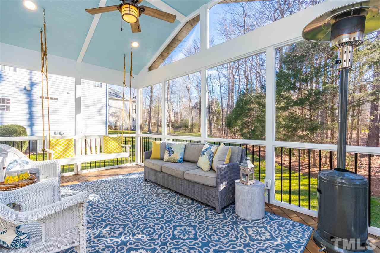 8240 Clarks Branch Drive Raleigh, NC 27613 - Photo 27 of 30 a living room with furniture and a floor to ceiling window