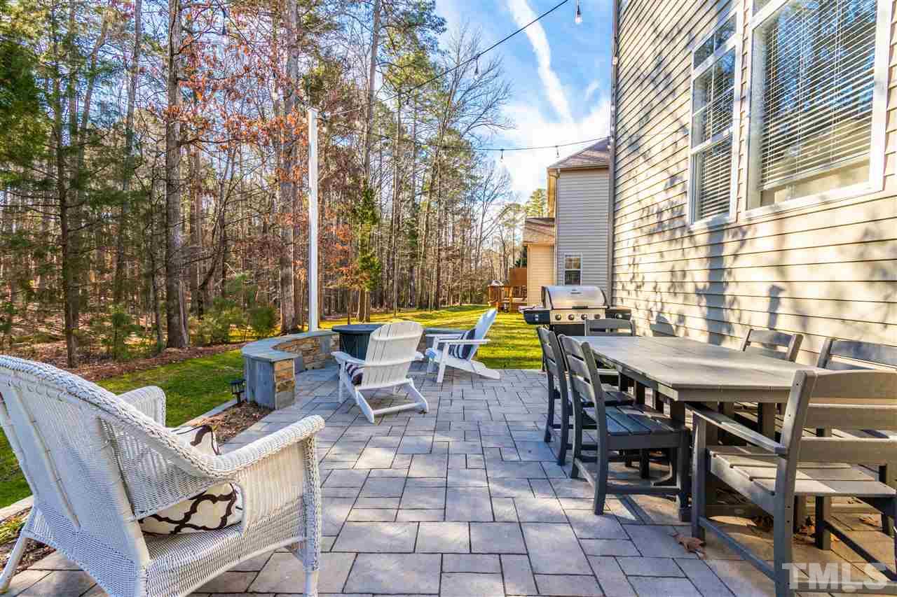 8240 Clarks Branch Drive Raleigh, NC 27613 - Photo 29 of 30 a view of a patio with a table and chairs and couches