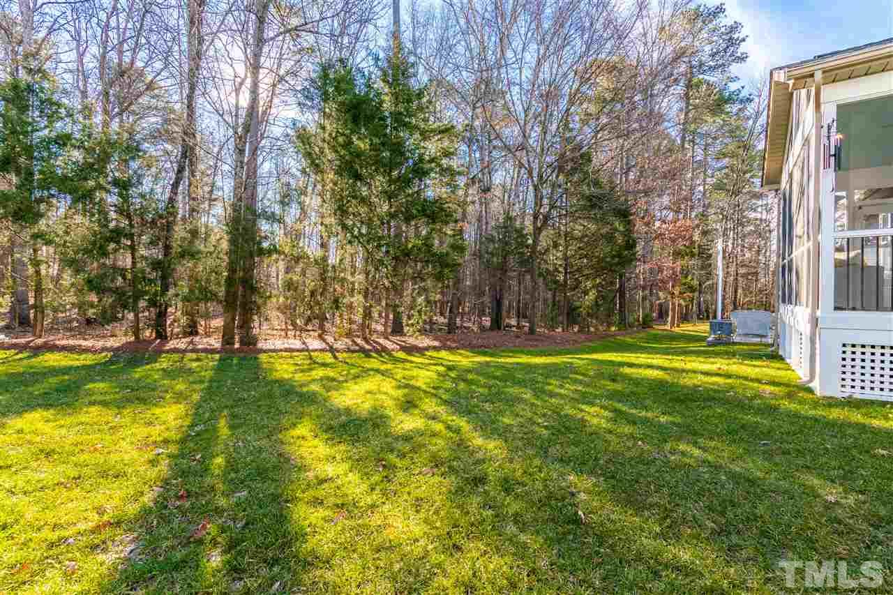 8240 Clarks Branch Drive Raleigh, NC 27613 - Photo 30 of 30 a view of swimming pool with lawn chairs and large trees