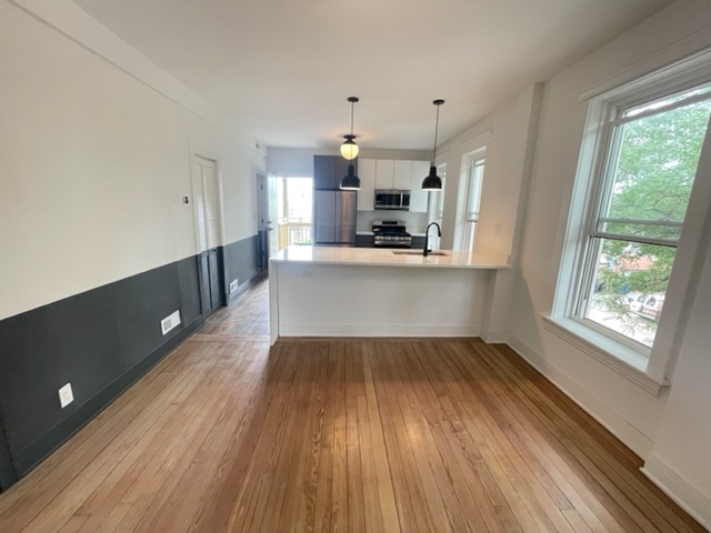 2159 West Huron Street, Unit 2R Chicago, IL 60612 - Photo 2 of 13 a view of a kitchen with wooden floor and electronic appliances
