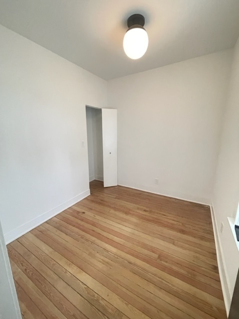 2159 West Huron Street, Unit 2R Chicago, IL 60612 - Photo 7 of 13 a view of empty room with wooden floor