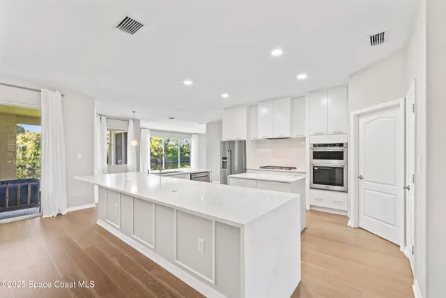 a spacious bathroom with a sink double vanity and a mirror