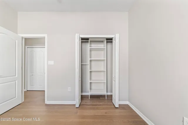 a kitchen with white cabinets and sink