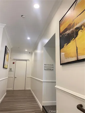 a view of a hallway with wooden floor