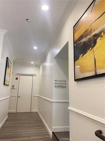 a view of a hallway with wooden floor