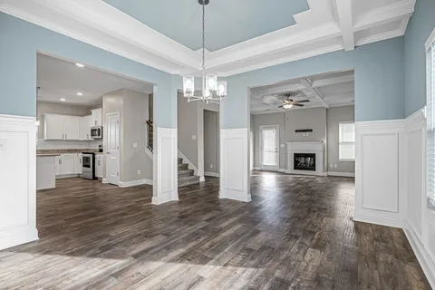 a view of a kitchen with a sink and an empty room