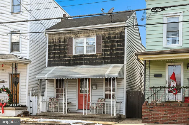 a view of a house with wooden fence