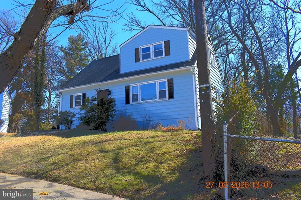 a view of a house with brick walls plants and covered with yard