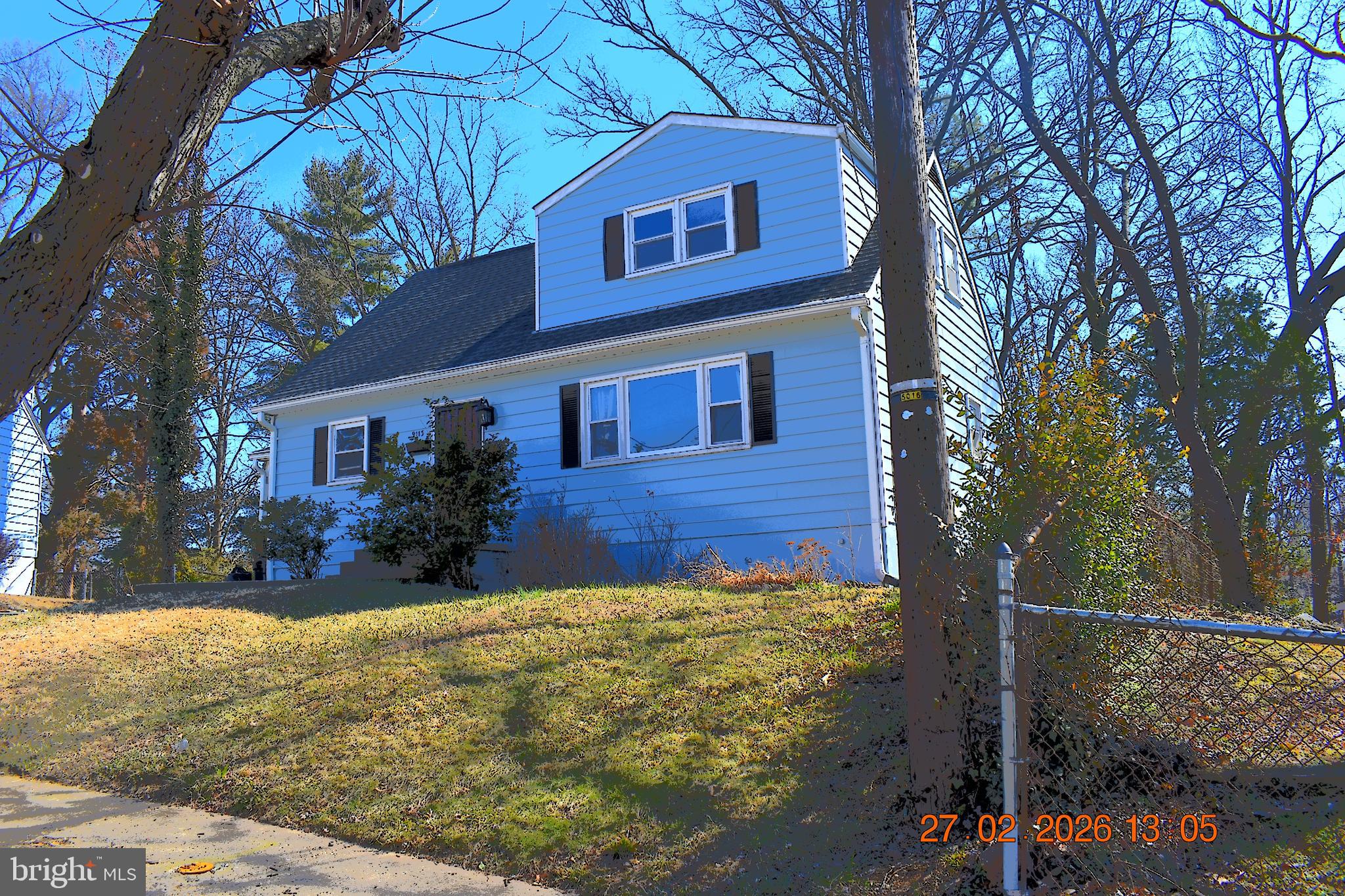 9113 Kinzer Street Lanham, MD 20706 - Photo 1 of 6 a view of a house with brick walls plants and covered with yard