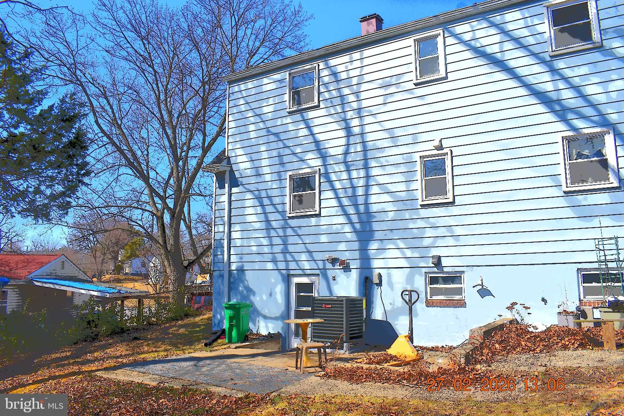 9113 Kinzer Street Lanham, MD 20706 - Photo 2 of 6 a view of a patio with a table and chairs under an umbrella
