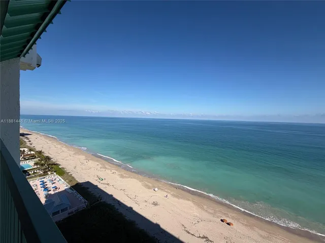 a view of swimming pool with outdoor seating and lake view