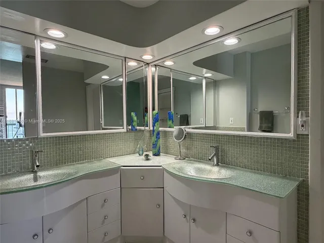a bathroom with a sink double vanity and a mirror