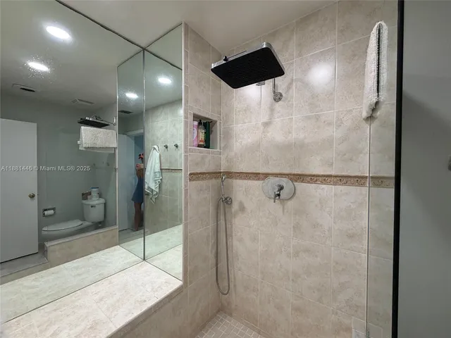 a bathroom with a shower and a sink