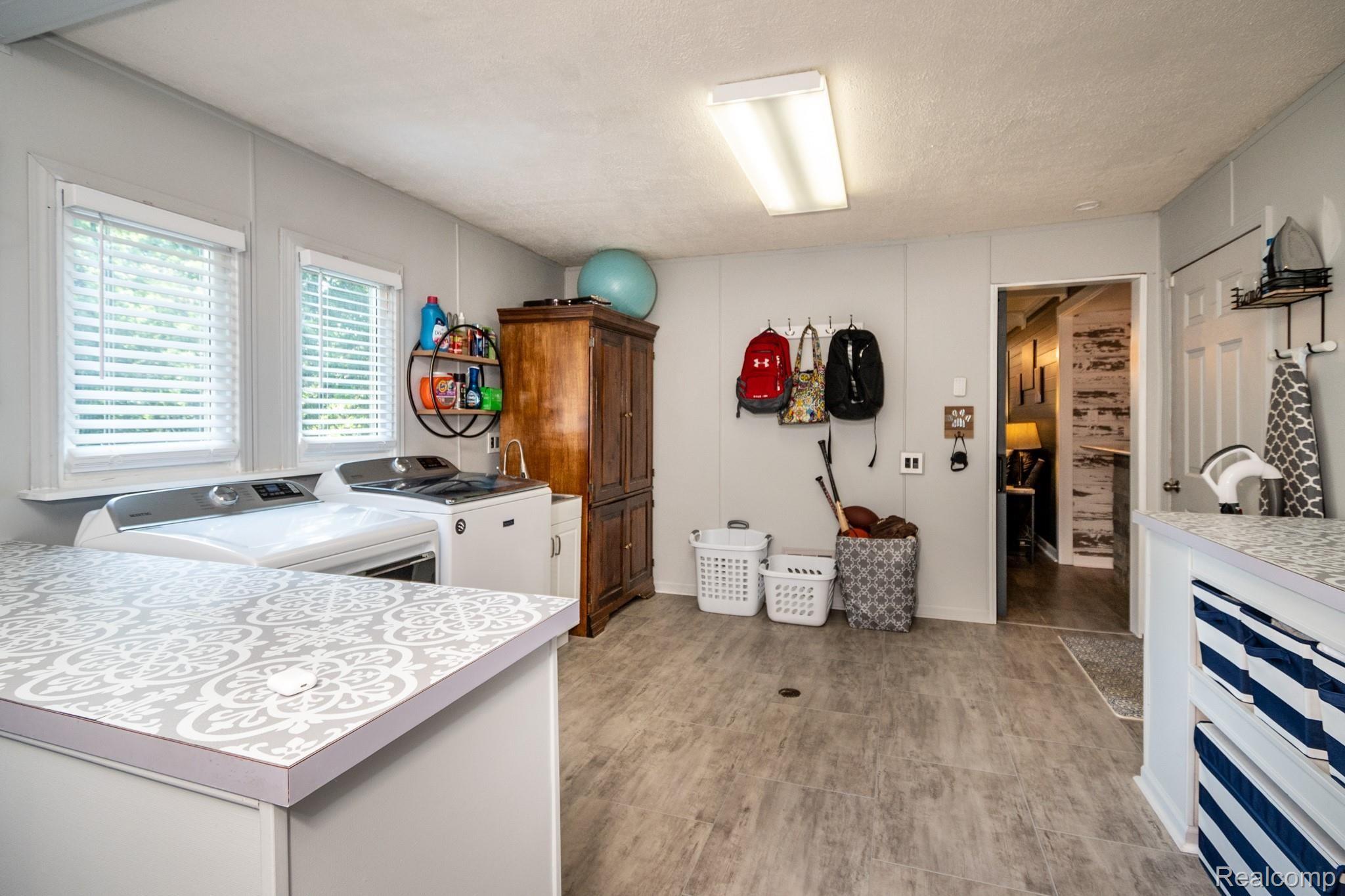 616 Campus Road Rochester, MI 48309 - Photo 19 of 38 Storage options and extra room in laundry area offers workout or craft space.