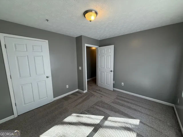 a view of a room with wooden floor and cabinet
