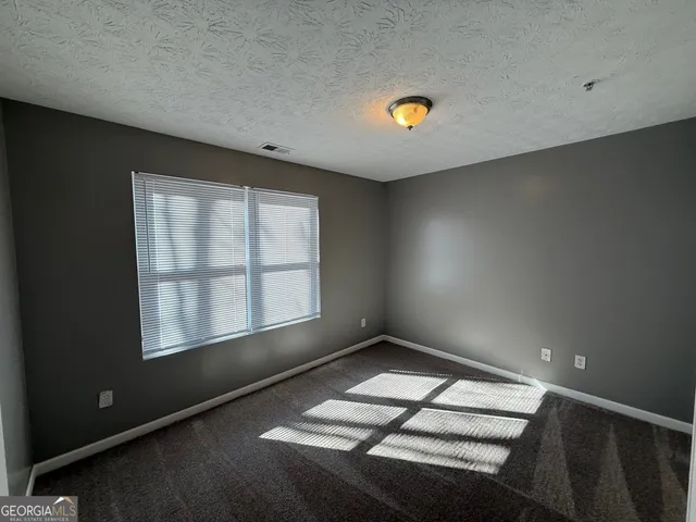 a view of empty room with windows