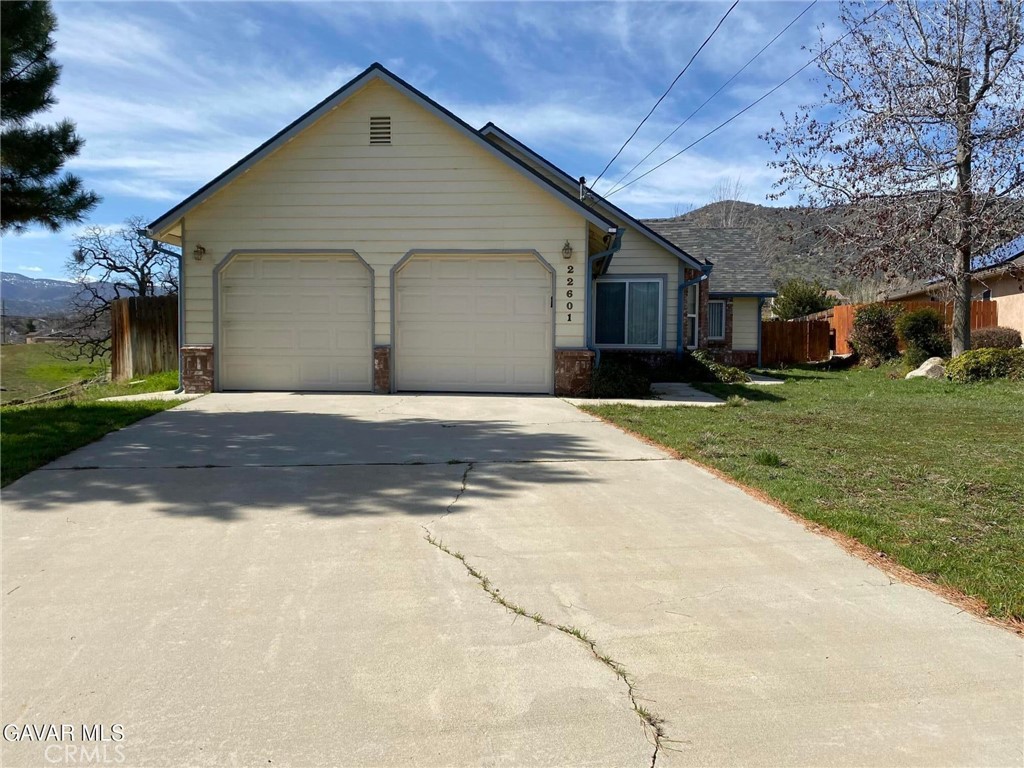 22601 Player Court Tehachapi, CA 93561 - Photo 1 of 10 a front view of a house with a yard and garage