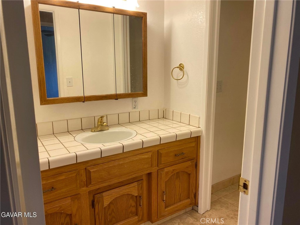 22601 Player Court Tehachapi, CA 93561 - Photo 10 of 10 a bathroom with a sink and a mirror