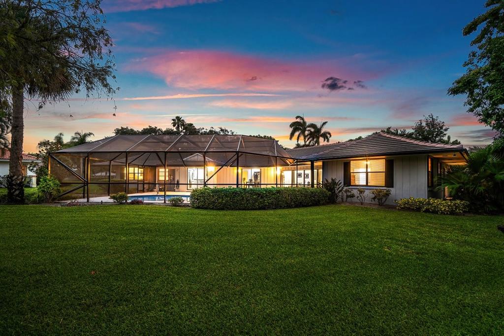 10158 Southeast Acorn Way Jupiter, FL 33469 - Photo 38 of 39 a front view of a house with a garden