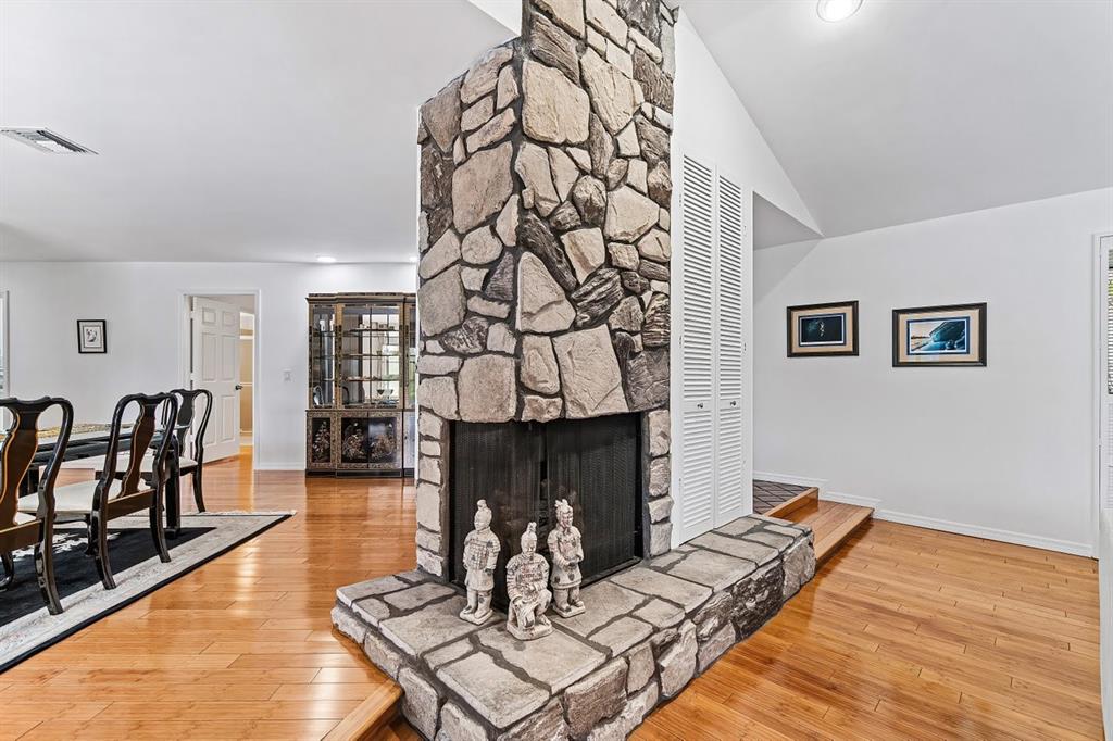10158 Southeast Acorn Way Jupiter, FL 33469 - Photo 5 of 39 a living room with furniture a rug and a fireplace