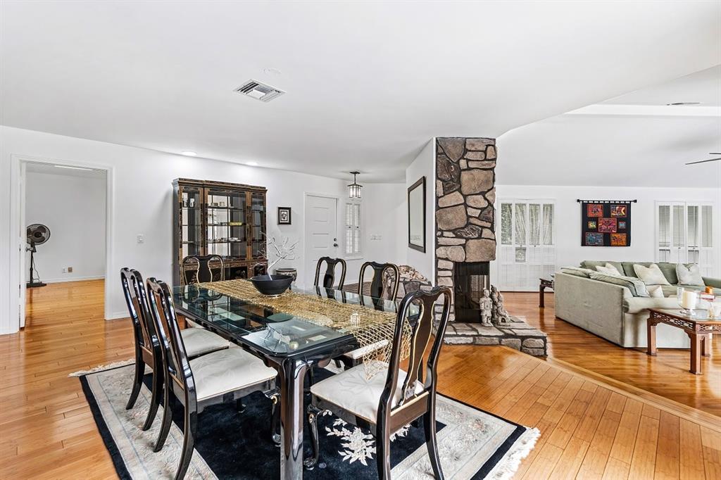 10158 Southeast Acorn Way Jupiter, FL 33469 - Photo 6 of 39 a view of a dining room with furniture and wooden floor