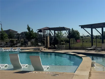 a view of swimming pool with chairs