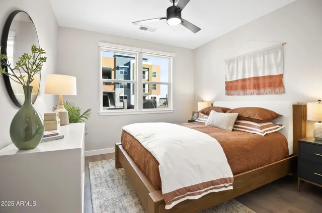 a bedroom with a bed and wooden floor